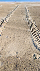 background sandy footprints parallel on floor beach track from car wheel of vehicle on the sand