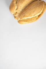 Traditional Spanish candeal bread loaf on white background