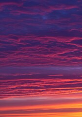 A vibrant sunset with streaky purple and pink clouds.

