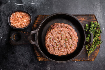 Grilled hamburger beef meat patties, chooped roast meat. black background. top view