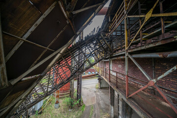 Fototapeta premium Abandoned Heavy Industrial Ruins with Large Blast Furnace in Steelworks