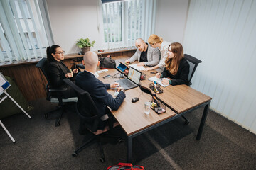 Business colleagues discussing and collaborating in a modern office setup, showcasing teamwork,...
