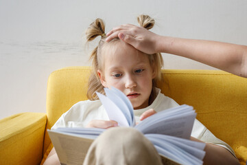 Parent hand on head of child girl