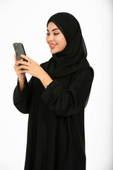 Portrait of an arab woman on a white background using mobile.