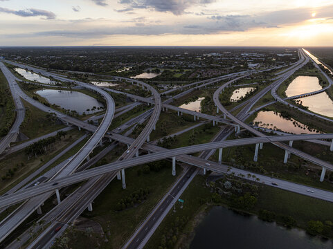 Aerial view of the intricate web of highways converging at the sawgrass interchange reflecting the golden light of the setting sun, Sunrise, Florida, United States.