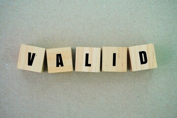 Wooden cubes with the words valid. based on truth or reason; able to be accepted