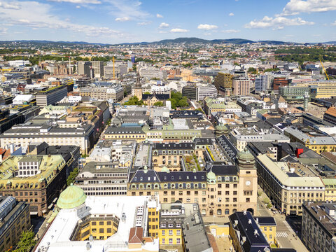 Aerial view of Oslo's city center, where buildings' varied heights and colors create a vibrant tapestry under a clear sky, Oslo, Oslo, Norway.