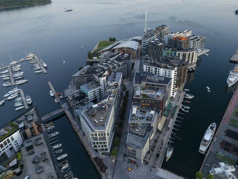 Aerial view of a modern architectural landscape where sharp lines of buildings meet the tranquil harbor waters surrounding Aker Brygge, Oslo, Oslo, Norway.