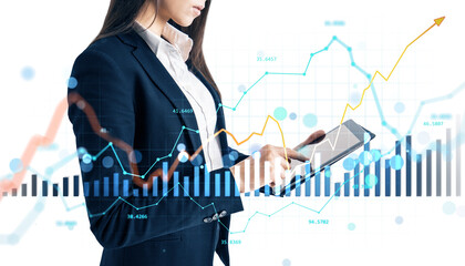 Woman in business suit using a tablet with forex and stock market charts overlaid, on white background. Concept of digital financial analysis