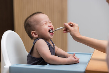 Happy baby enjoy tasty food at table
