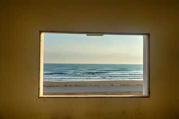 An open window overlooking the sea and the seaside road. It's like a hyperrealistic painting...