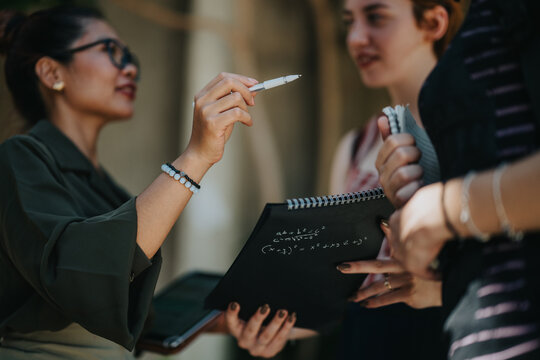 A professor explains equations to students, fostering learning in an outdoor school environment.
