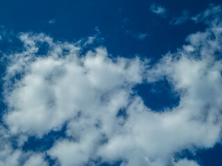 Blue sky with white and dark clouds.