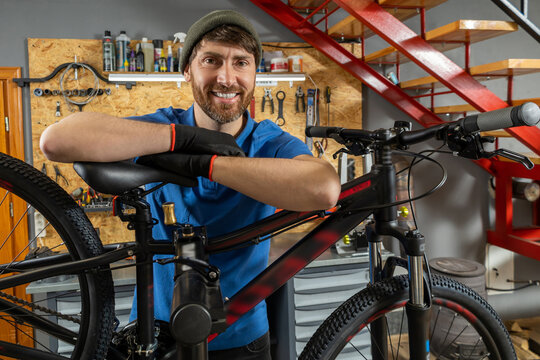 Bearded bike repair specialist working in organized workshop