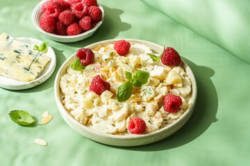 fresh cauliflower salad with dor blue cheese and raspberries
