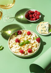 fresh cauliflower salad with dor blue cheese and raspberries