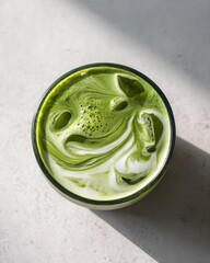 Iced Matcha Latte - Top View with Swirling Milk and Green Tea