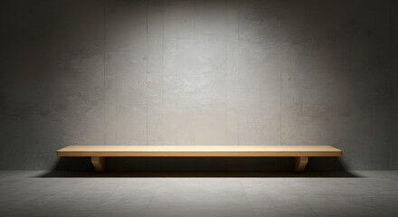 Minimalist interior featuring a wooden bench against a textured gray concrete wall with soft spotlight illumination