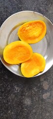 The image shows cut Alphonso mangoes, a premium variety of mangoes known for their distinct characteristics. 