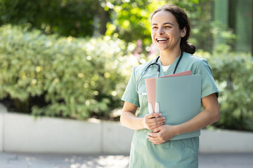 Happy smiling young female doctor in a lab coat
