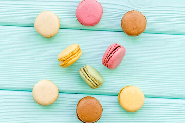Macarons dessert pattern on mint green background top view