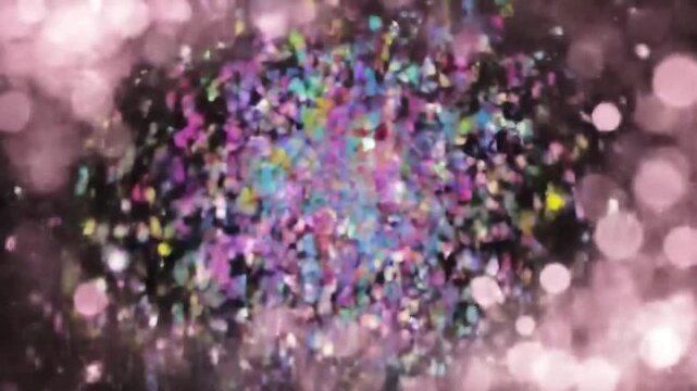 Multicolor confetti scattered against a dark backdrop highlighted by blurry pink light effects