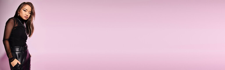 Stylish young woman showcases modern fashion in vibrant studio setting