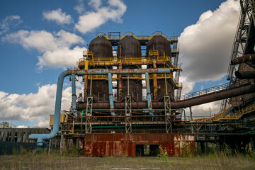 Fototapeta premium Abandoned Heavy Industrial Ruins with Large Blast Furnace in Steelworks