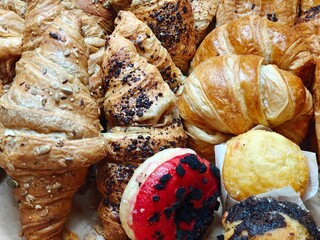 Croissants, donuts, and muffins for breakfast. Industrial pastries.