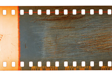 Dusty and grungy 35mm film texture or surface. Perforated scratched camera film isolated on white...