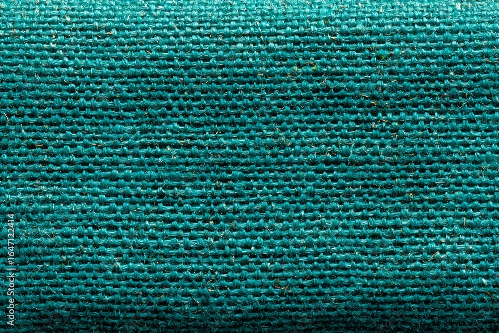 Poster close-up macro photograph showcasing the intricate woven texture of teal fabric, creating a visually