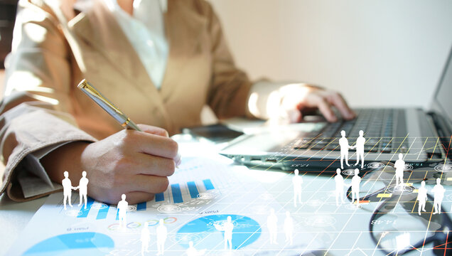 Businesswoman Working on Laptop with Financial Analysis - Powered by Adobe