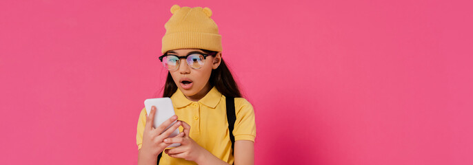 Stylish preteen girl excitedly prepares for school in a vibrant studio setting