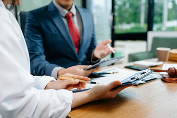 business people and lawyers discussing contract papers sitting at the table. Concepts of law,...