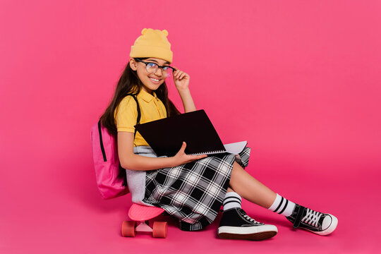 Stylish preteen girl ready for school with vibrant energy in a colorful studio