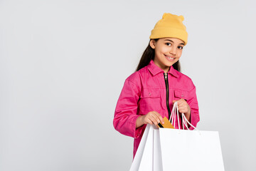 Trendy preteen girl showcases her stylish pink overalls for back to school preparations