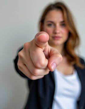 A woman points her finger confidently to convey her application, decision, and responsibility, by stating or giving orders.