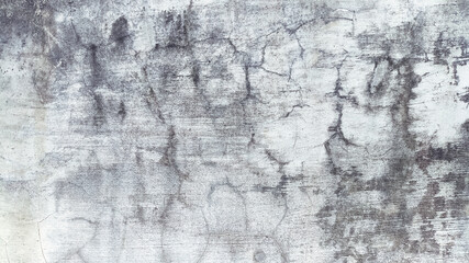 Surface of old concrete wall with patchy stains and rough cracks. Ideal for urban decay visuals or...