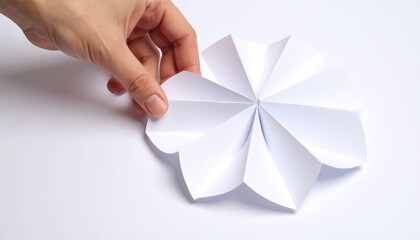 Hand Arranging White Paper Fan