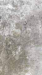 Aged cement wall showing heavy stains and cracks. Grunge texture suitable for digital backgrounds or damaged building inspection visuals.