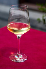  glass of white wine on a red table