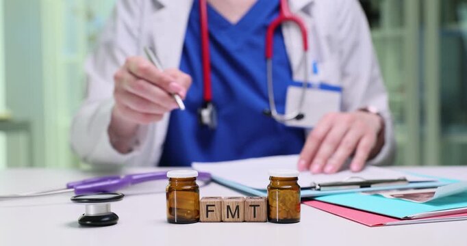 A healthcare professional meticulously records and analyzes data related to FMT treatment using advanced medical tools