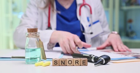 A skilled medical professional thoroughly examines various snoring solutions with specialized tools laid out on a desk