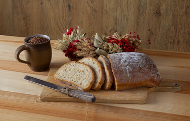 freshly sliced bread on a wooden cutting board no. 3, bread slicing knife, a delicious breakfast for morning coffee