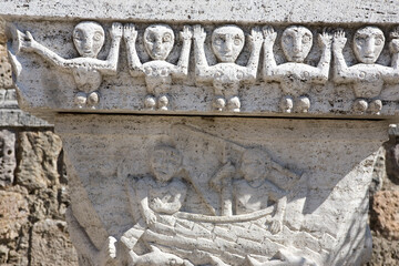 Ancient primitive stone carvings outside the church, Piazza Garibaldi, Monticiano, Tuscany, Italy