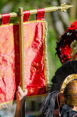Naklejka premium The red and gold standard of a roman legion held high in a parade or festival history and pride concept