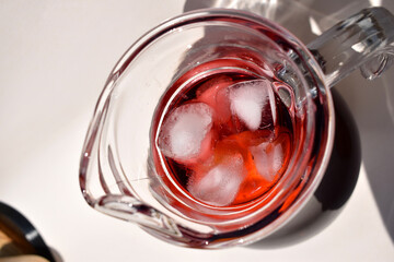 Close-up Refreshing Sangria in a Glass Pitcher with Ice, top view