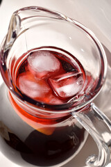 Close-up Refreshing Sangria in a Glass Pitcher with Ice, top view