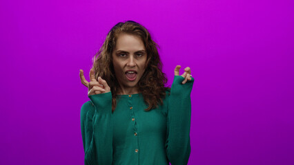 Young woman gesturing playfully against a vivid pink background, expressing emotion with curly hair...