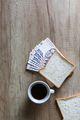 rich breakfast from Money Tender sandwich Ukrainian hryvnia and morning coffee